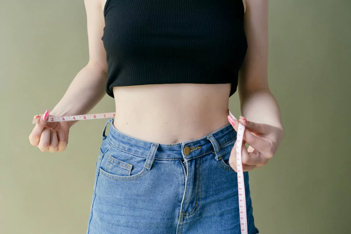 woman measuring waist showing progress with B12 injections for weight loss
