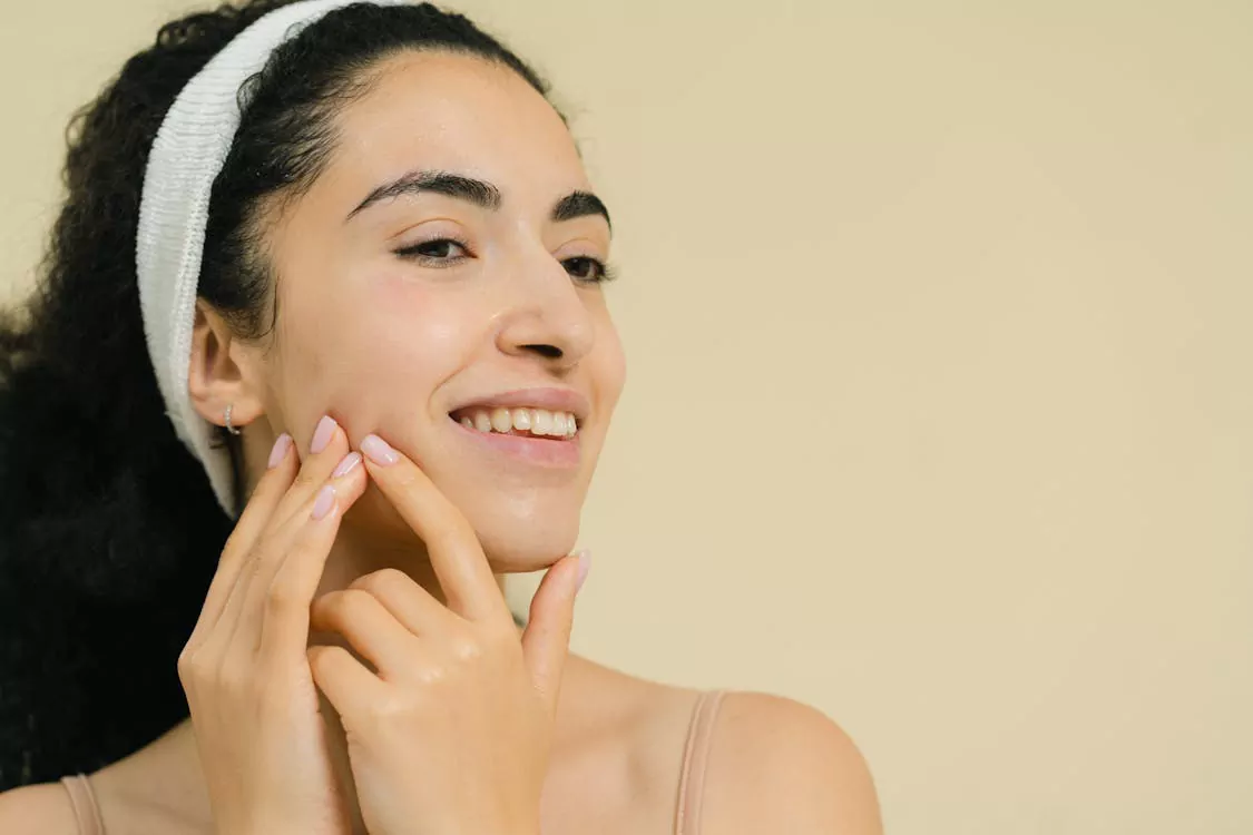 A woman with clear, glowing skin, highlighting the benefits of vitamin B12 for skin health and complexion