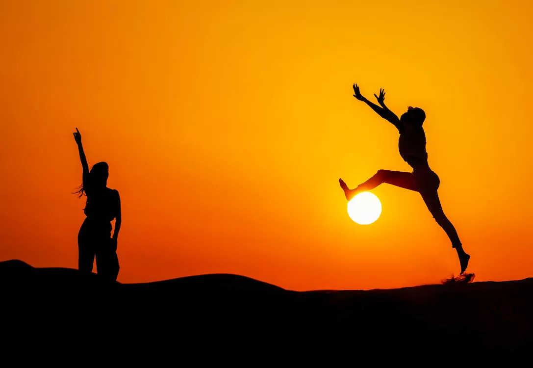 increased-energy-vitamin-b12-injections-lifestyle - Daytryp RX Silhouettes of people jumping at sunset symbolize increased energy and vitality from vitamin B12 injections.