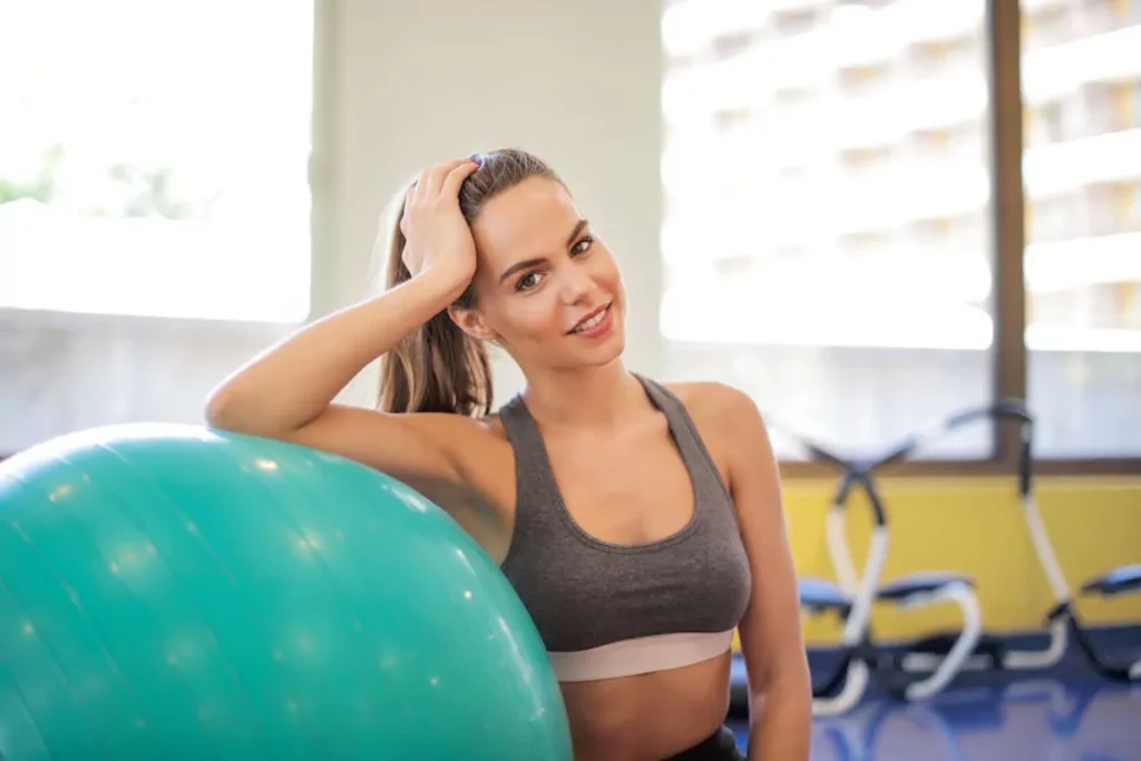  A woman resting on an exercise ball, representing improved energy and fitness support from lipotropic injections
