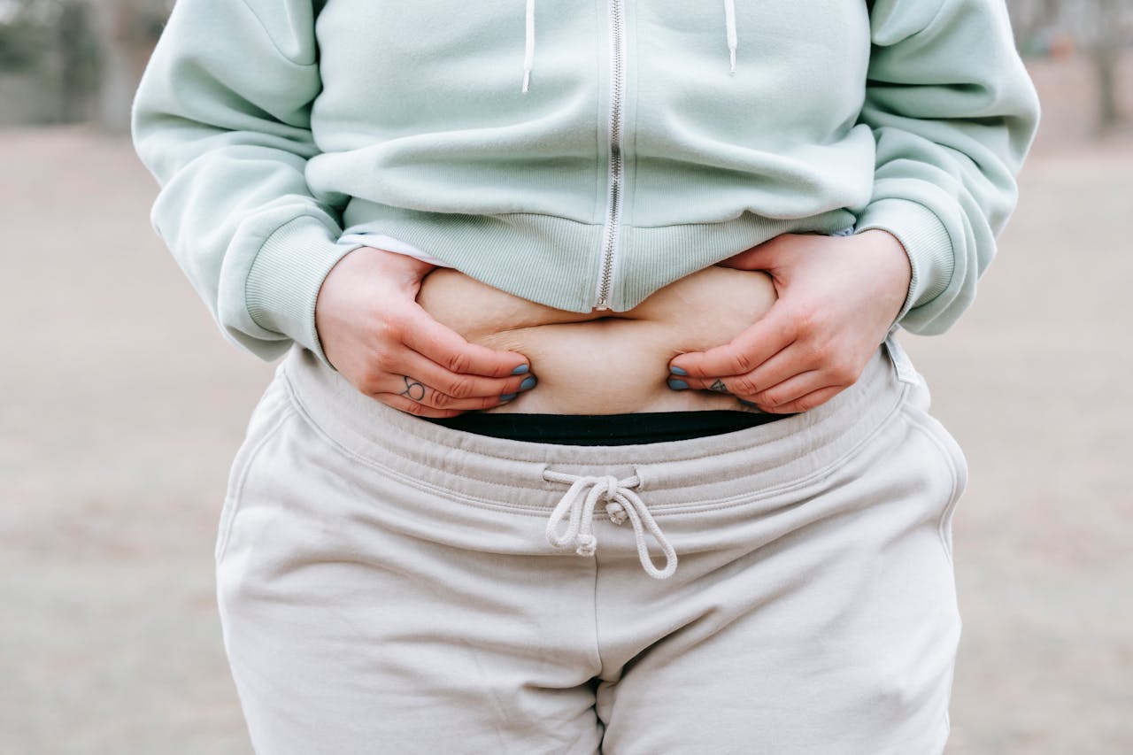 person holding stomach area representing energy levels and weight management supported by mic b12 injections
