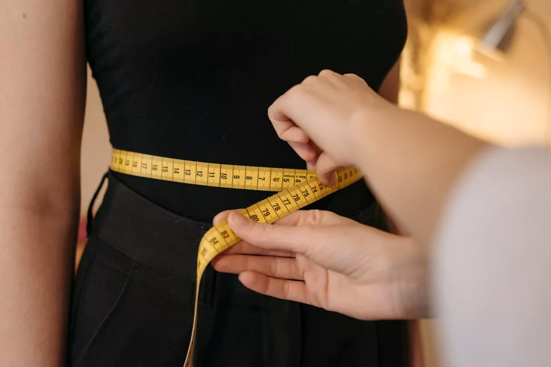nad-plus-metabolism-weight-management - Daytryp RX Person getting their waist measured.