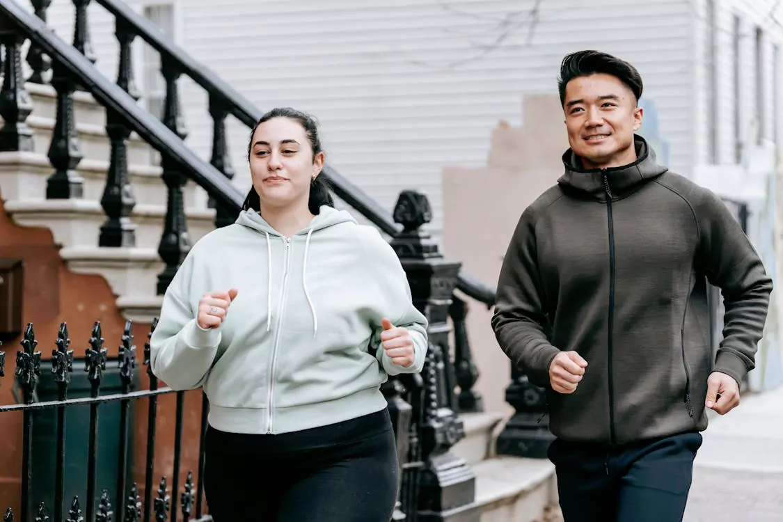 A man and a woman jogging outdoors, representing improved cardiovascular health and weight loss with Ozempic.