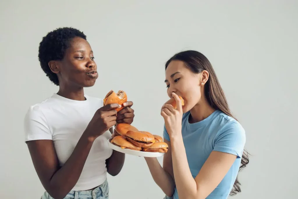 Two people eating burgers on a plate