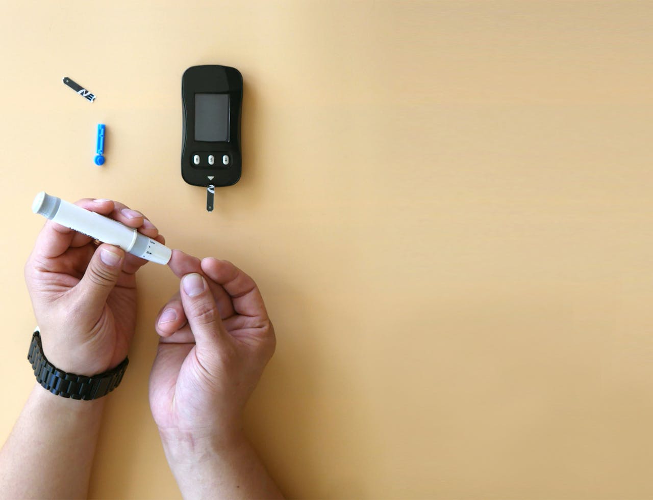 A person using a blood glucose meter 