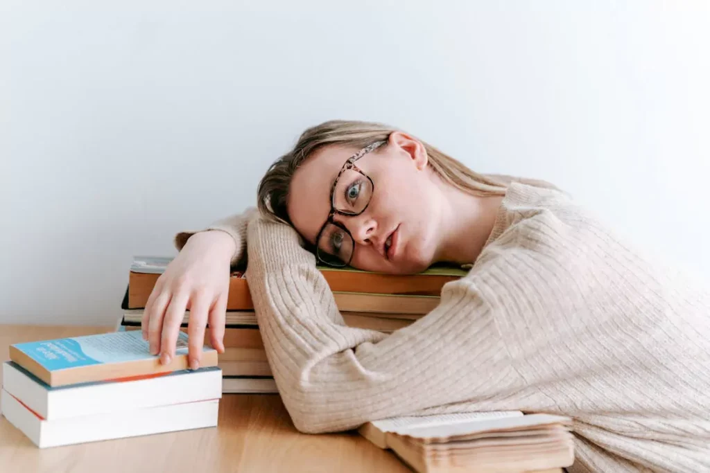 A person lying on books