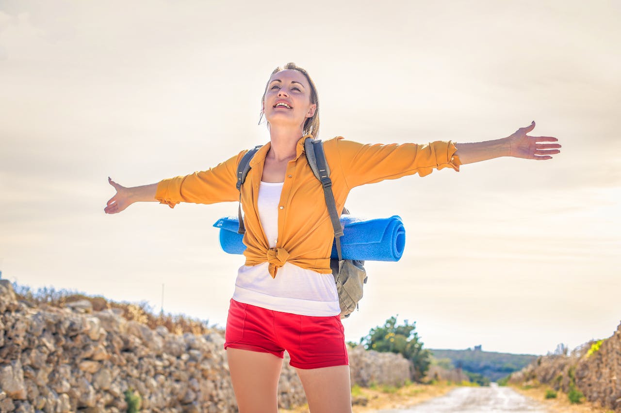 A person carrying a bag and a yoga mat 