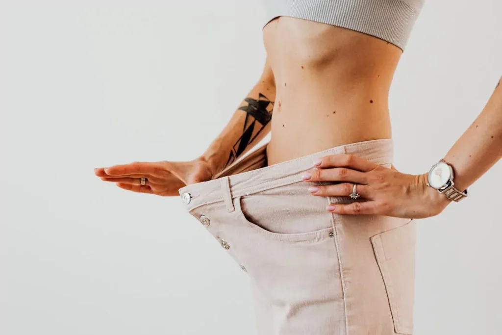person showing weight loss progress by wearing loose pants after semaglutide treatment online