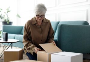 A middle-aged woman opening a package at home.