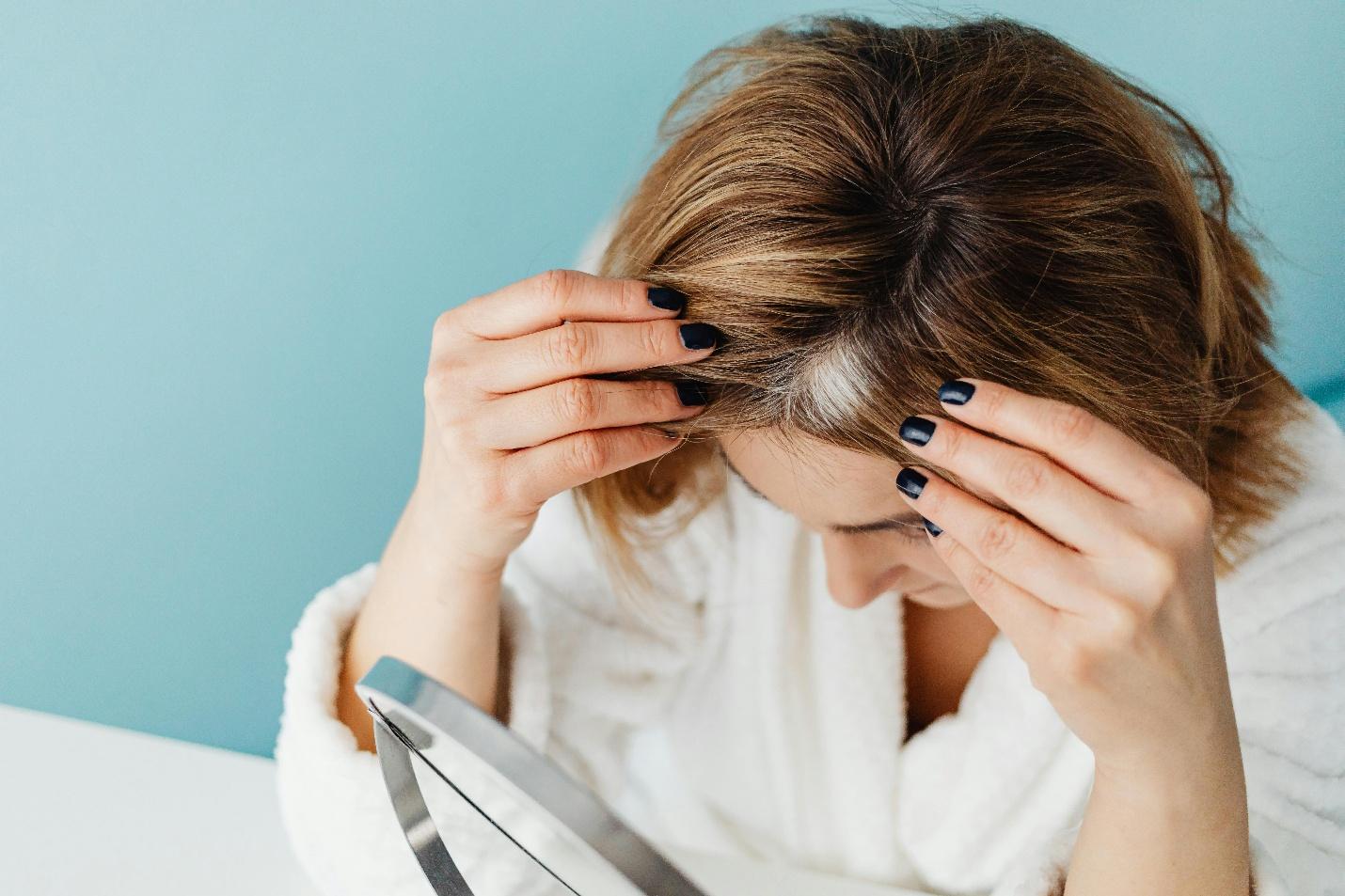 A person touching her hair