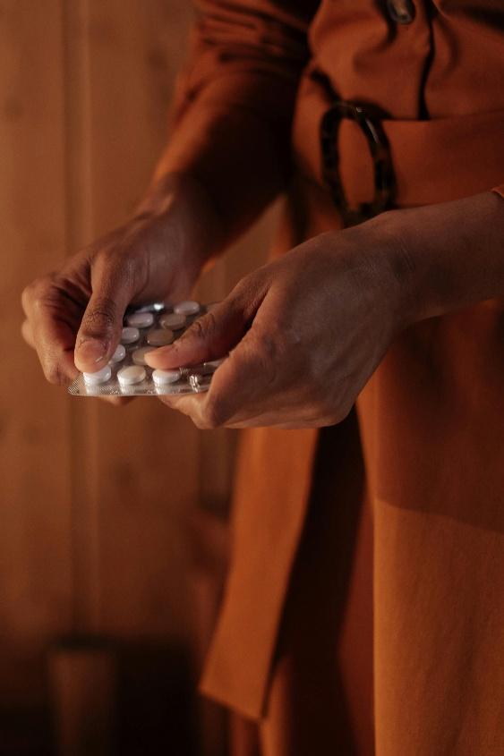 A person holding pills