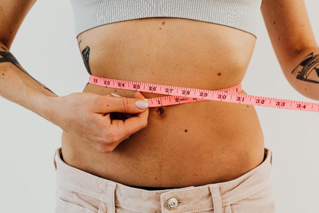 A person measuring their waist