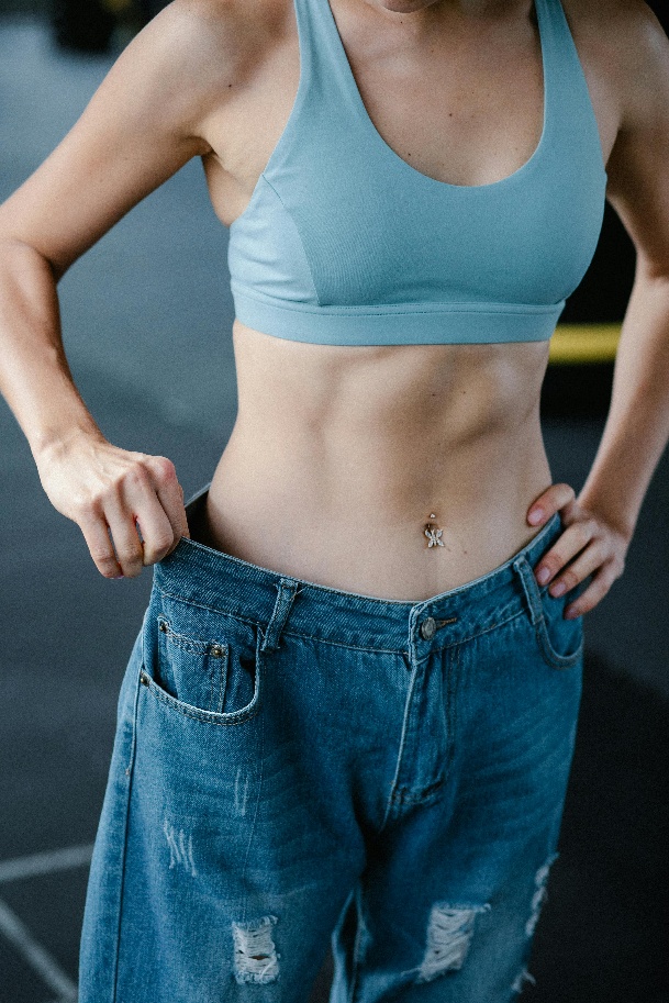 A person measuring their waist