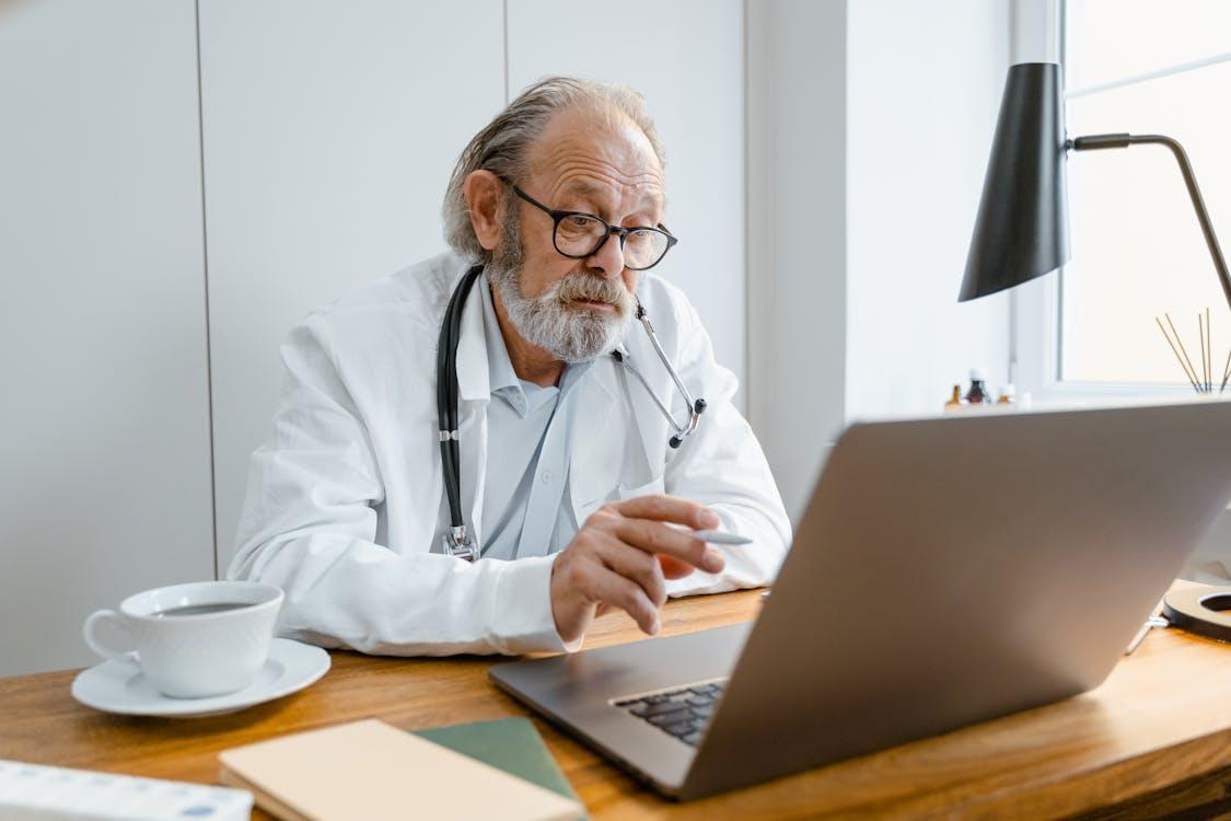 Doctor conducting a virtual mental health consultation from a laptop