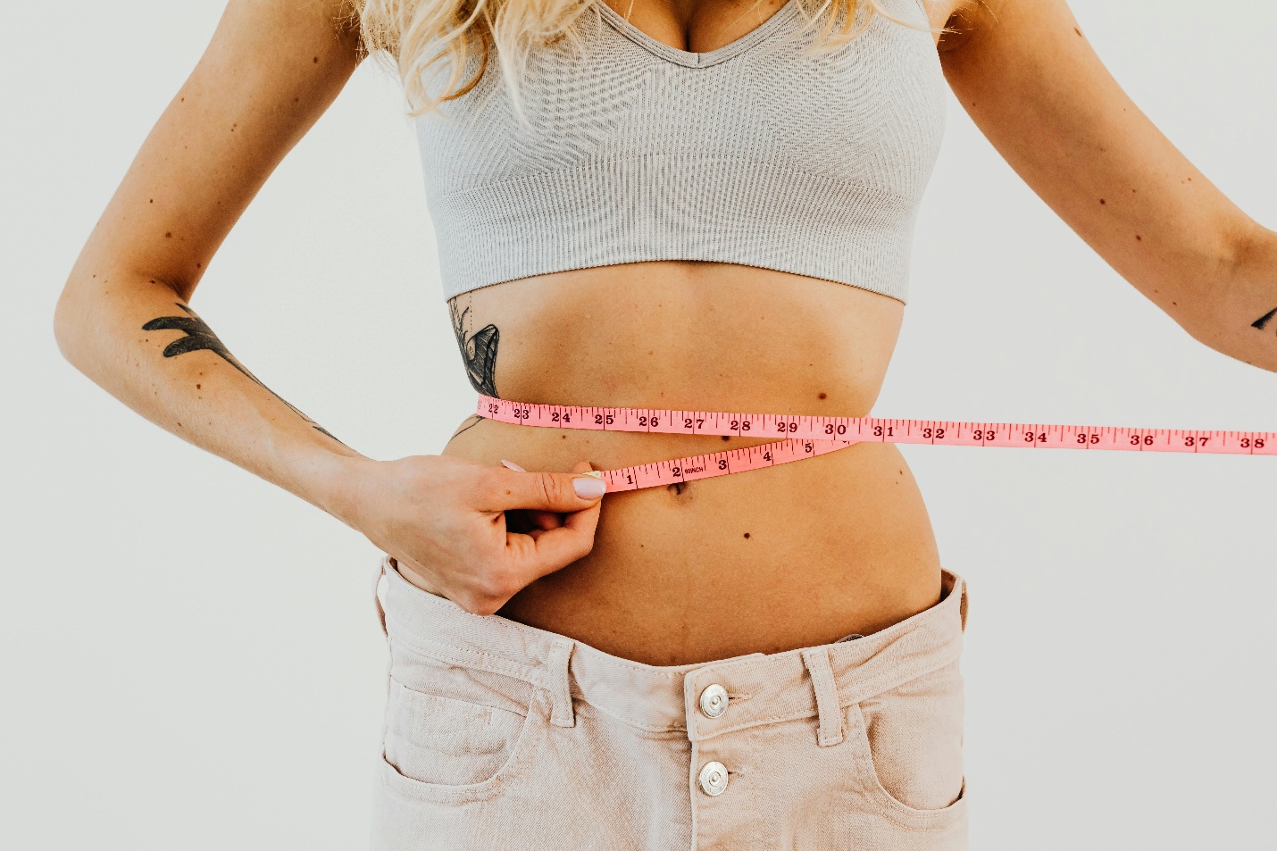A person measuring their waist