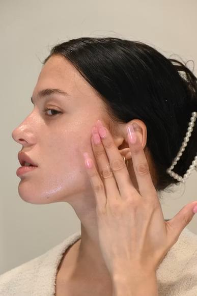 An image of a woman with her hand on her face