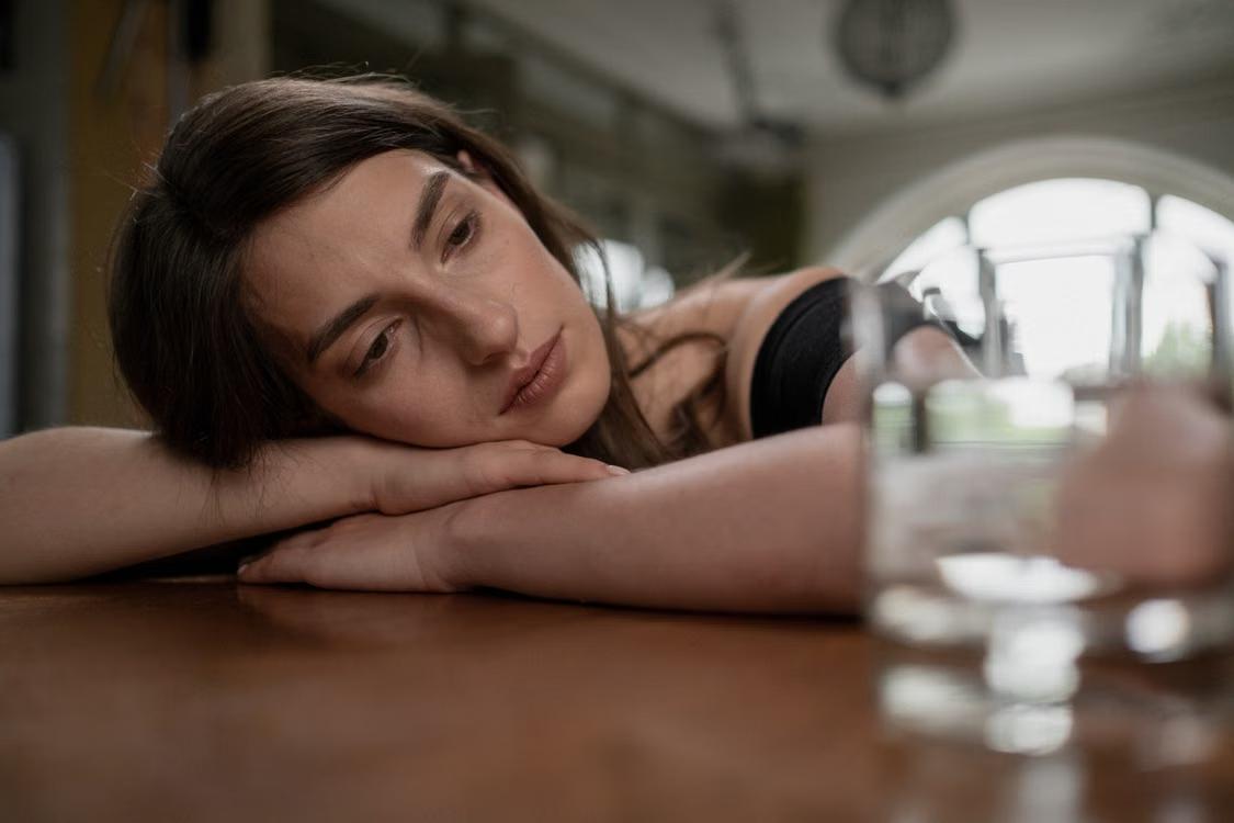 woman reflecting on mental health treatment options in a supervised ketamine therapy setting