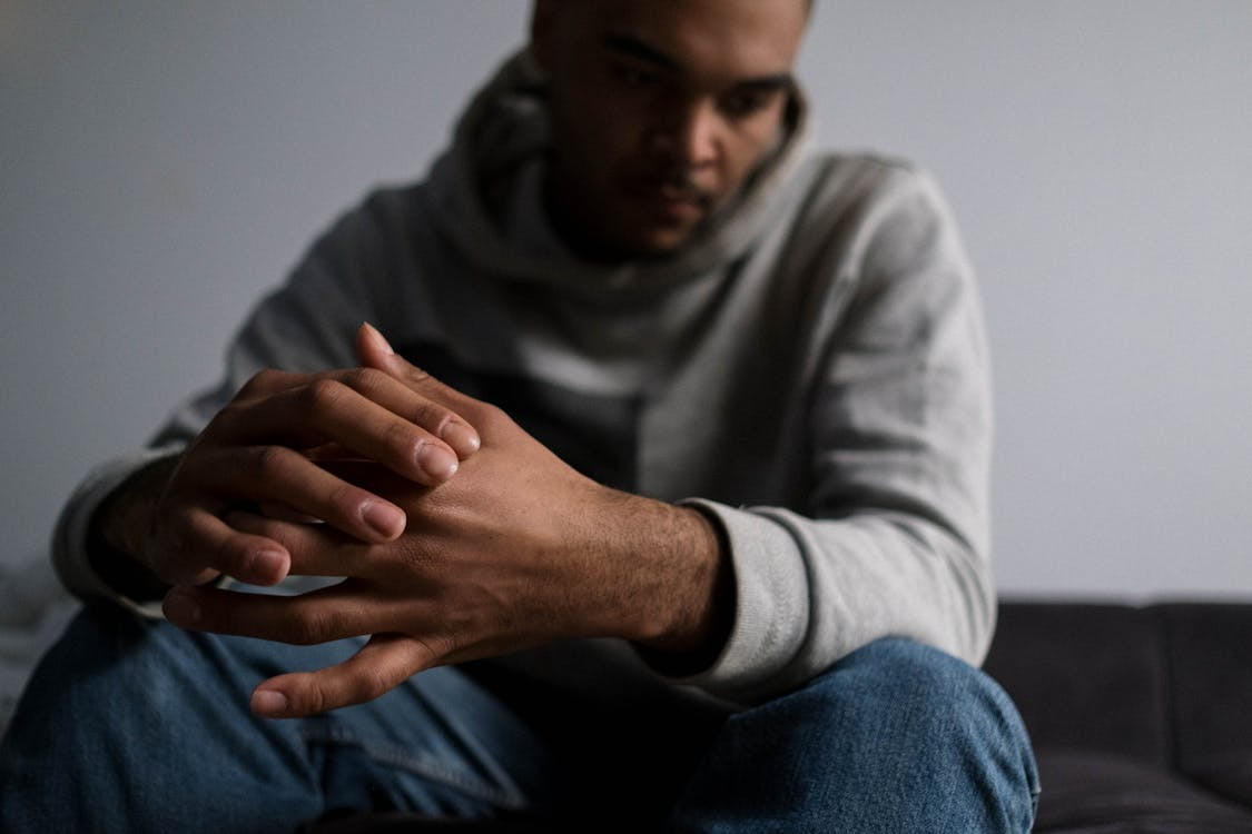 man sitting alone struggling with depression and mental health challenges