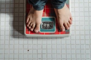 An image of a person standing on a weighing scale