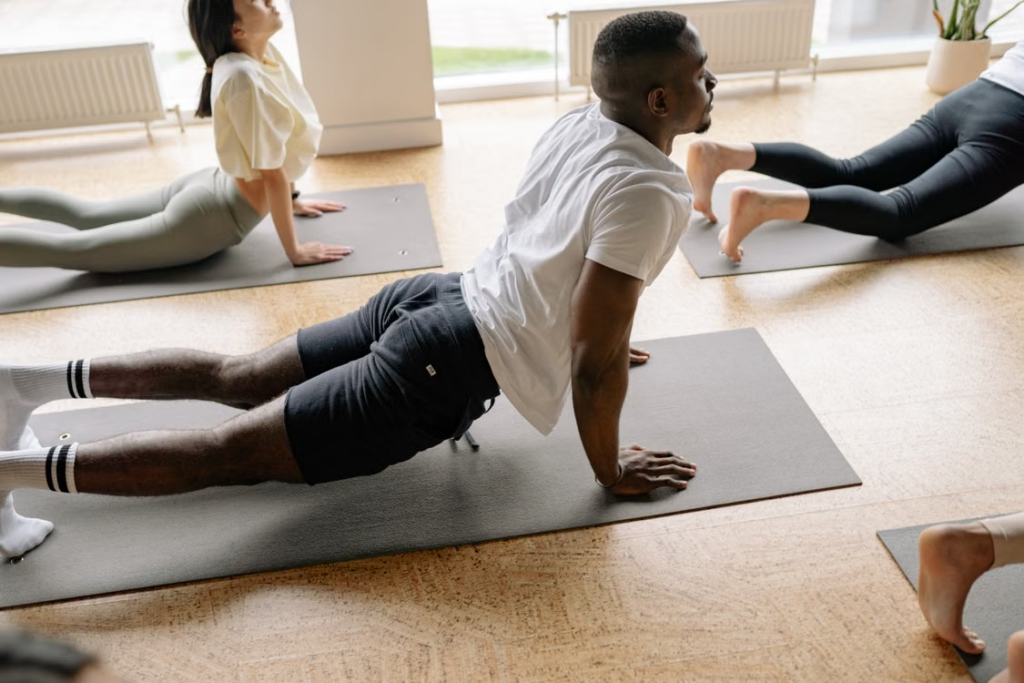 longevity-protocols-nad-glutathione-peptides - Daytryp RX man stretching during a wellness routine representing coordinated NAD, glutathione, and peptide protocols