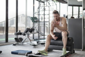 man resting after a workout representing testosterone replacement therapy and natural hormone production