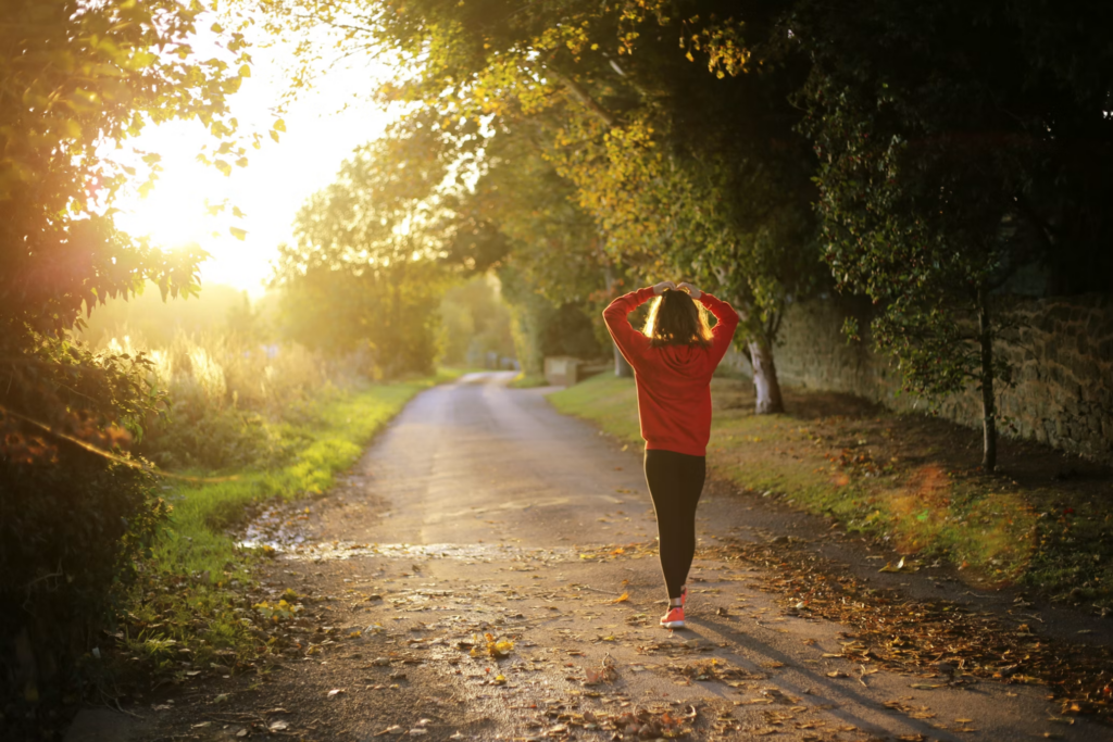 woman walking along a peaceful path representing long-term mental health recovery and integration after ketamine therapy