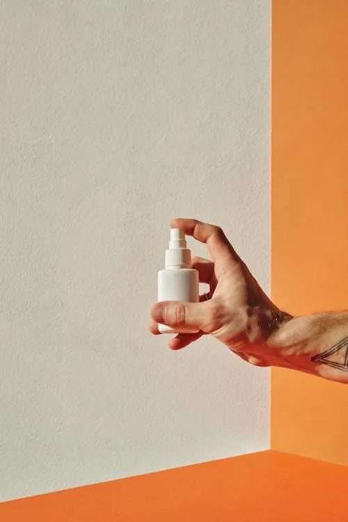 Hand holding a nasal spray bottle representing ketamine nasal spray treatment and pricing considerations