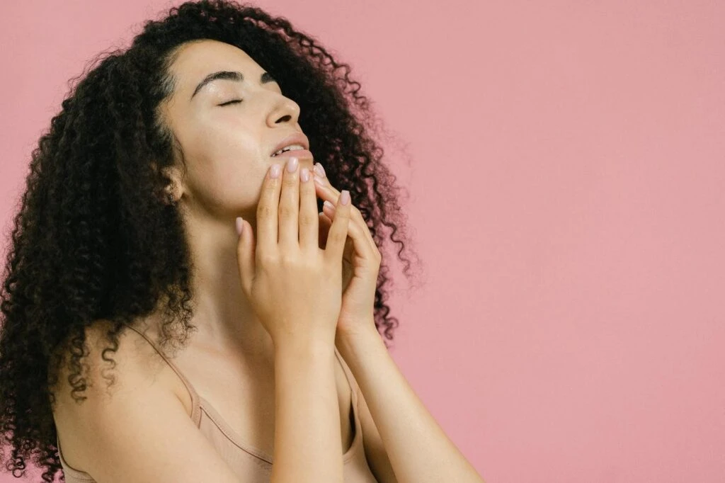 A woman touching her face