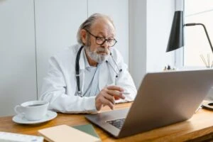 Doctor conducting a virtual mental health consultation from a laptop