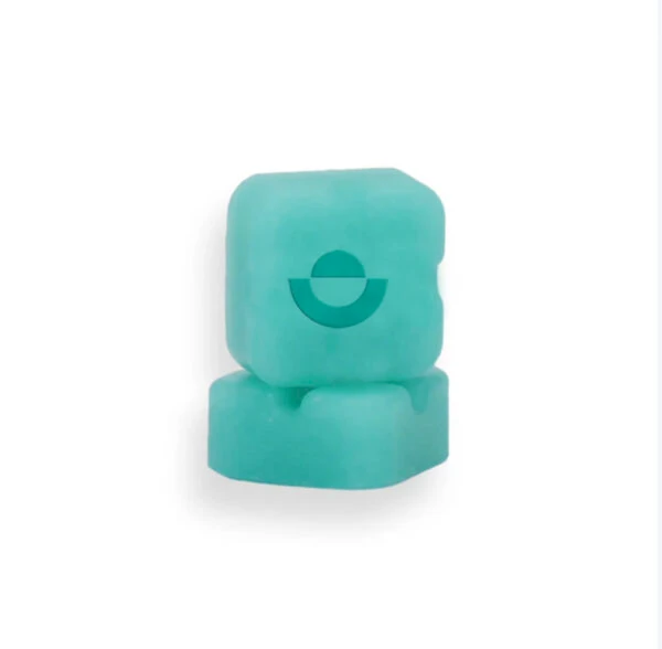 Two stacked turquoise lozenges with a circular logo, representing wellness supplements or edibles.