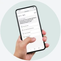 Hand holding smartphone displaying Daytryp Rx online questionnaire on a light background. - Daytryp RX Hand holding smartphone displaying Daytryp Rx online questionnaire on a light background.