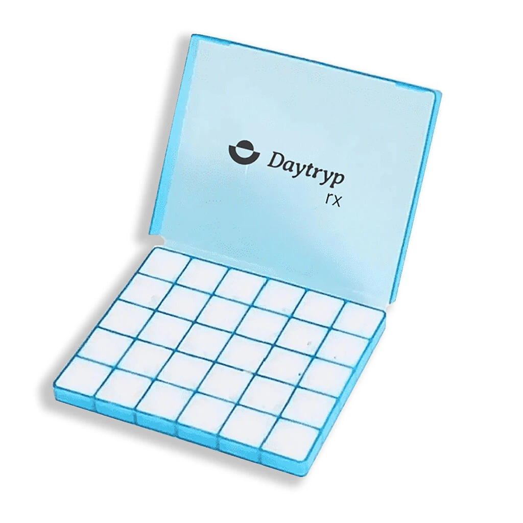 Open box of Daytryp Rx branded ketamine troches, each individually sectioned, representing 100mg ketamine lozenges used for mental health therapy and mood support.