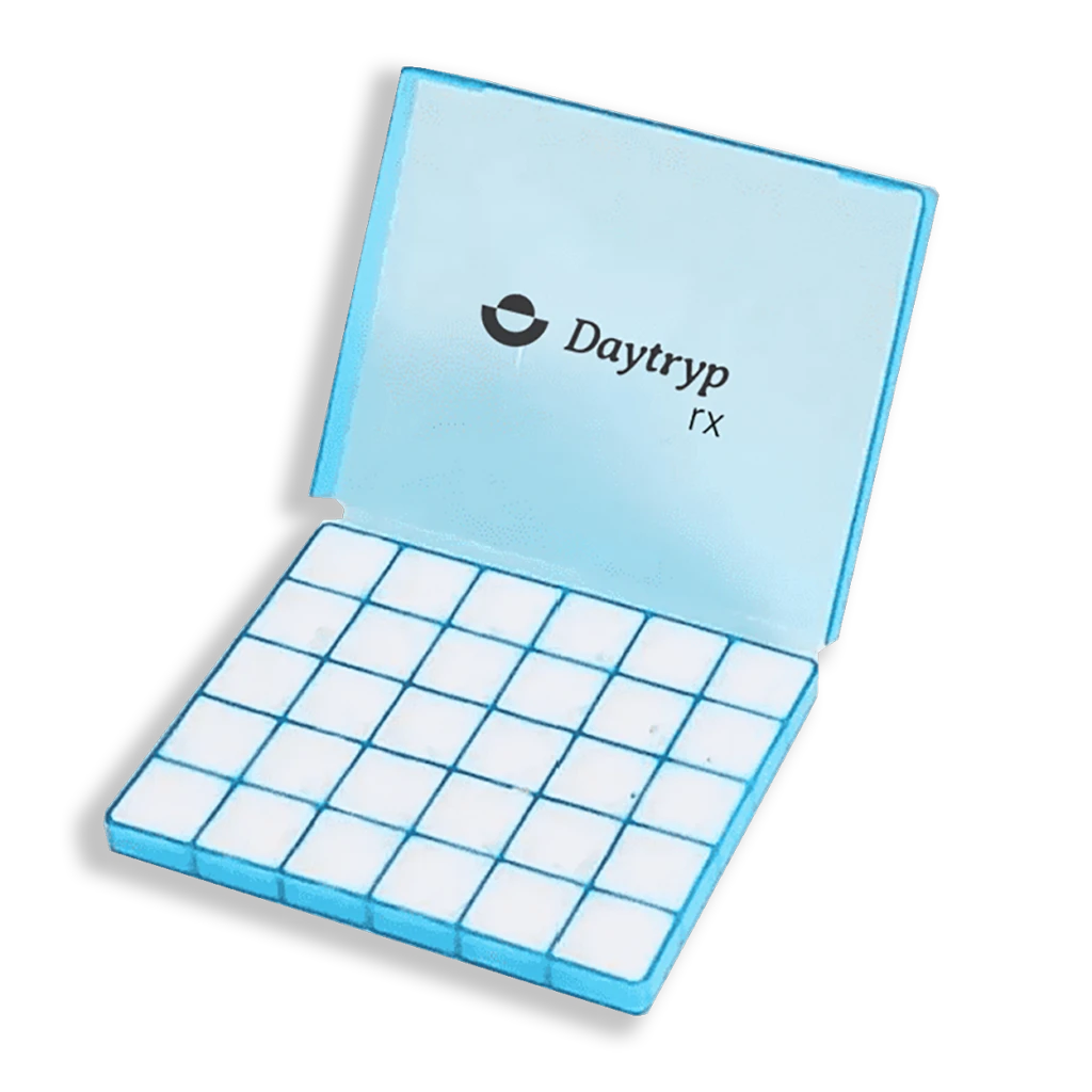 A light blue open pill organizer with 25 square compartments. The lid has the text "Daytryp rx" and a logo.